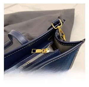 Close-up of premium denim texture with contrast stitching and golden metal hardware