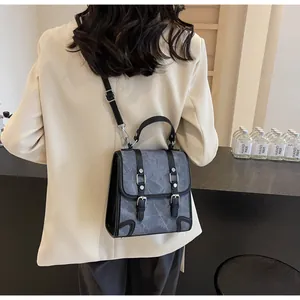 Detail of retro mini backpack with marble pattern and adjustable leather straps on model