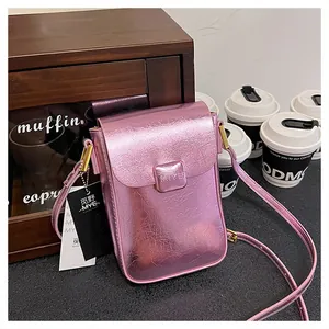 Detail of metallic pink mini phone bag showing crinkled texture and golden hardware