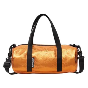 Metallic orange cylinder pillow bag with black handles and adjustable shoulder strap