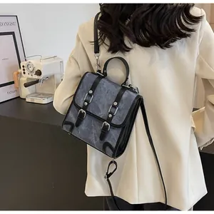 British style backpack shown from behind on model with adjustable straps and retro hardware