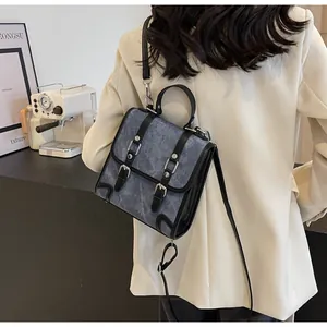Detail view of vintage British style multi-use backpack with buckled straps and texture