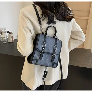 Detailed back view of a grey marble texture backpack on model with leather strap details