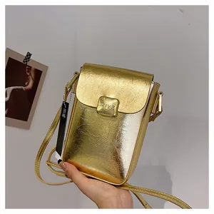 Detail of mini gold textured leather crossbody phone bag with square metallic clasp