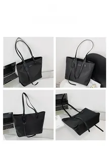 Detail view of large capacity black nylon tote bag with leather straps and logo plaque