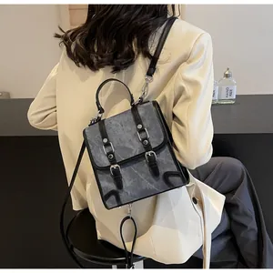 Close-up of vintage multi-way backpack with leather straps on a fashion model back