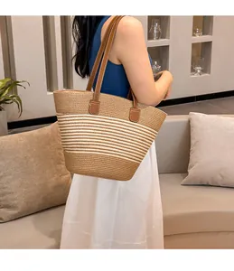 Detail of hand-woven straw tote with striped pattern and premium leather shoulder straps