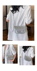 Detail of silver crossbody bag with woven leather texture and adjustable strap