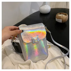 Detailed macro view of holographic mini phone bag with golden metal buckle and silver finish