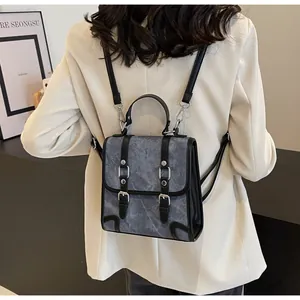 British retro backpack detail showing grey-blue matte texture and silver buckle straps
