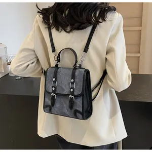 Detailed back view of a retro British style backpack with adjustable black leather straps