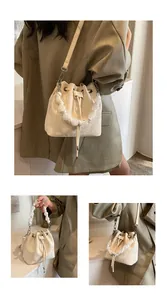 Detail view of beige drawstring bucket bag with unique large translucent beaded handle