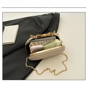 Internal capacity of gold sequin evening bag showing space for phone and makeup
