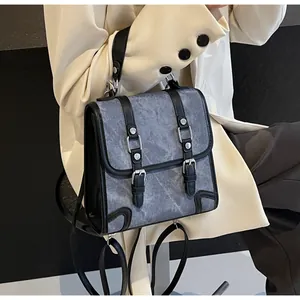 Detail of vintage grey marble texture fabric backpack with black leather straps and buckles
