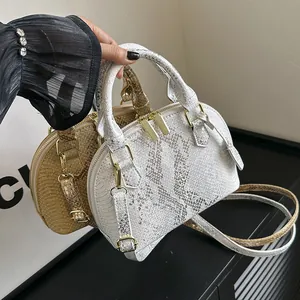 Golden and silver shell-shaped crossbody bags with metallic snakeskin texture and handles