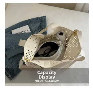 Capacity display of hollow out tote bag with silver inner pouch for daily essentials