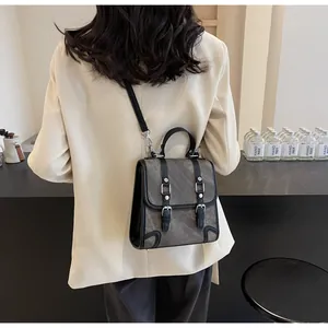 British vintage crossbody bag shown on a model in a smart cream blazer and casual style
