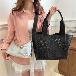 Chic black laser-cut hollow tote bag with silver metallic inner pouch for women