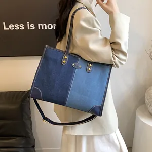 Fashionable denim patchwork tote bag with gold rivets and adjustable shoulder strap for women