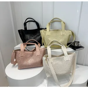 Minimalist laser-cut tote bags in four colors with top handles and wide shoulder straps