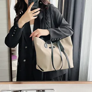 Minimalist beige waterproof nylon tote bag with black leather straps and large capacity