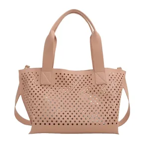 Fashionable hollow-out tote bag in light brown leather with laser-cut hole design