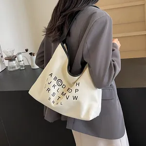 Minimalist canvas tote bag for women with black letter print and contrast piping trim