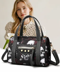 Detailed macro view of gothic skull and red floral print on black crossgrain leather bag