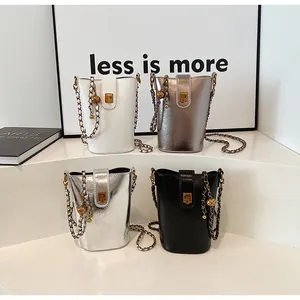 Vue détaillée de quatre petits sacs seaux en blanc, or, argent et noir avec bandoulières
