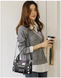 Fashion skull print boston bag with gold rivets and zipper detail shown by model