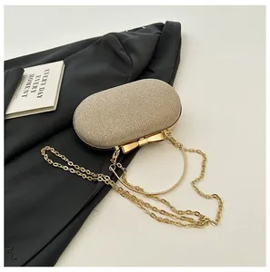 Detailed macro view of champagne gold evening bag with glittering sequins and metal bow clasp