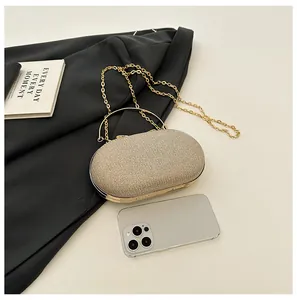 Detail showing dimensions of glitter evening clutch with champagne gold metal handle