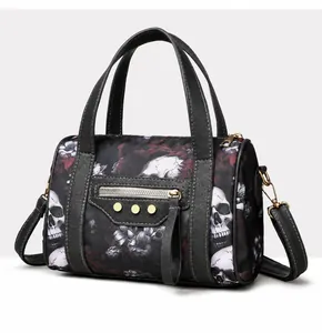 Detailed side view of gothic skull print bowling bag with white stitching and gold studs