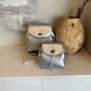 Mini-Rucksack aus silbernem Metallic-Leder mit Drehverschluss und Kettenriemen-Detail