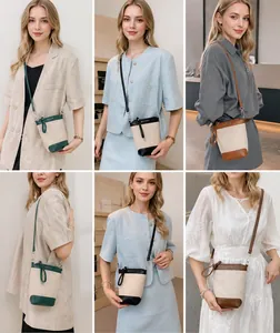 Détails du sac seau en toile avec garniture en cuir coloré et fine bandoulière amovible