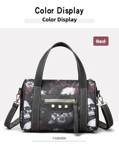 Detail of red boston bag featuring vintage skull floral print and golden rivets