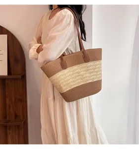 Close-up of handmade straw tote bag featuring contrast colors and woven hollow patterns