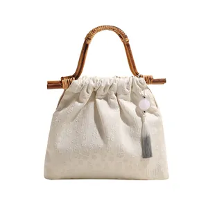 Oosterse beige jacquard handtas met vintage bamboe handvat en stijlvolle kwastjes