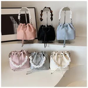 Showcase of drawstring bucket bags in six colors with stylish large beaded handles