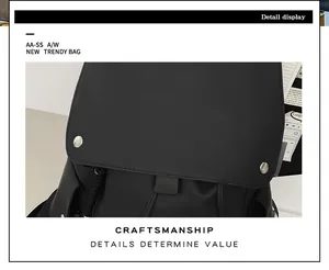 Detail display of black backpack top flap with matte leather and silver hardware