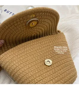 Detail of straw bucket bag showing natural woven texture and magnetic metal closure