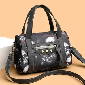 Detail of Boston bag with skull and red rose prints featuring gold rivets and zippers