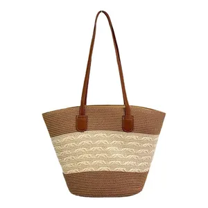 Handmade straw tote bag with brown leather straps and wave pattern for summer beach travel
