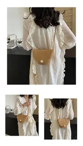 Detail of straw bucket bag with oversized pearl button and thin shoulder strap