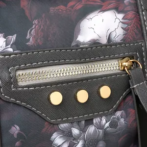 Close-up of cross-grain leather texture and skull floral print with gold-tone studs