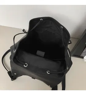 Detail view of large capacity black laptop backpack with drawstring and inner pocket
