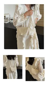 Detail showing handwoven bucket bag with pearl embellishment and thin shoulder strap