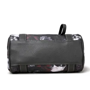 Macro shot of skull floral print fabric and grey saffiano leather base on cylinder bag