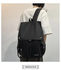 Detail view of black high-capacity backpack with metal buckles and drawstring closure