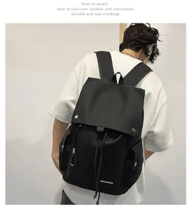 Detail of black waterproof nylon backpack with drawstring closure and metal buckles